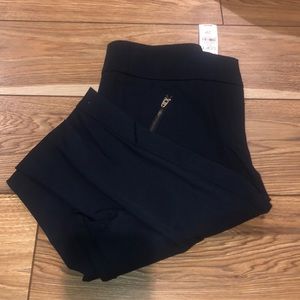 Blue dress pants with gold zippers.